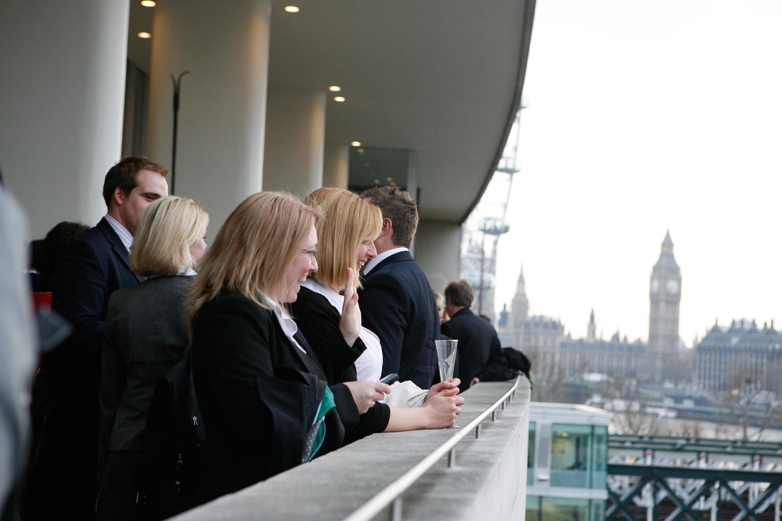 Guests attend a reception at the Southbank Centre, stood on the balcony overlooking the Thames