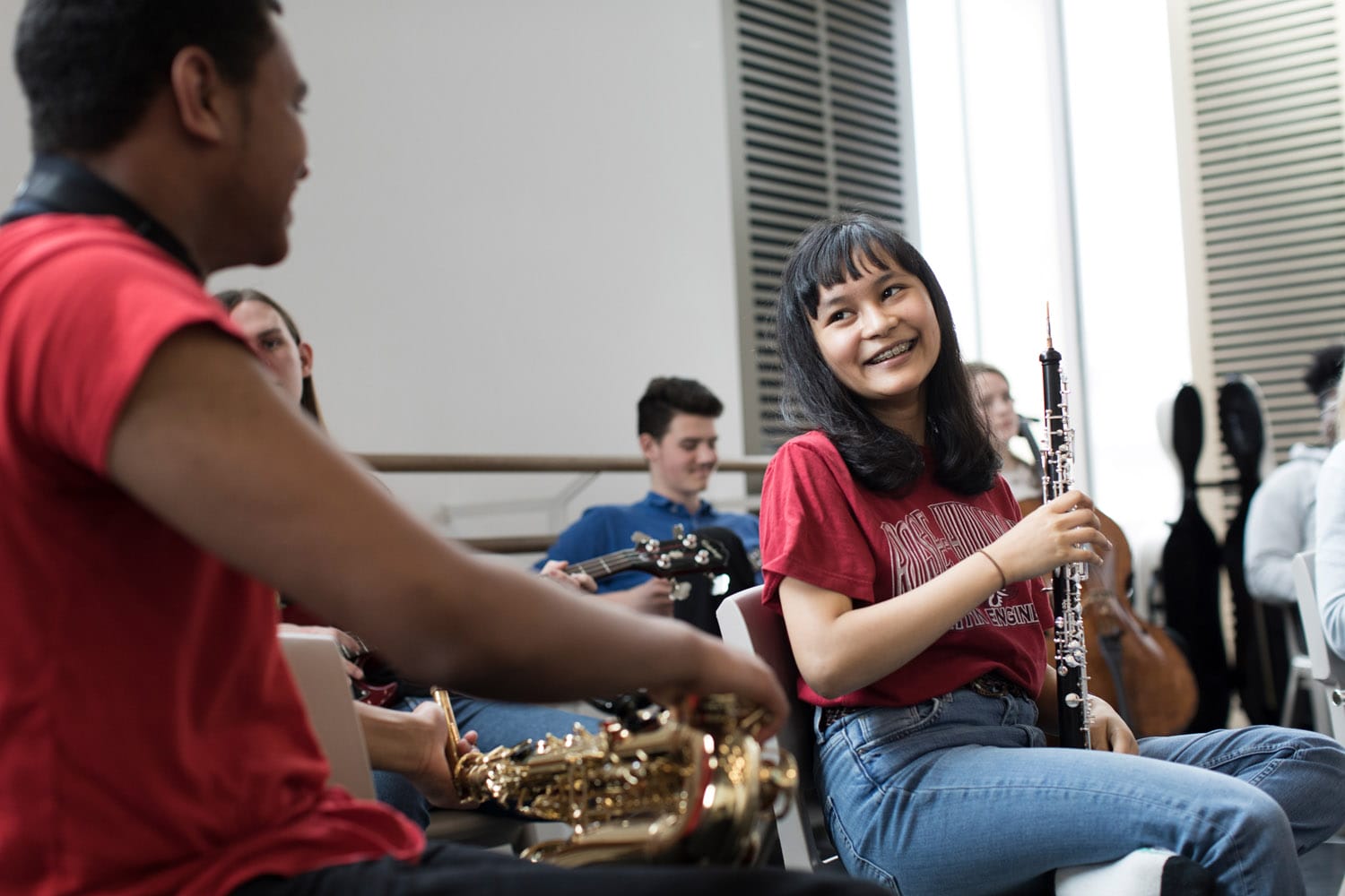 Two young musicians smile at one another