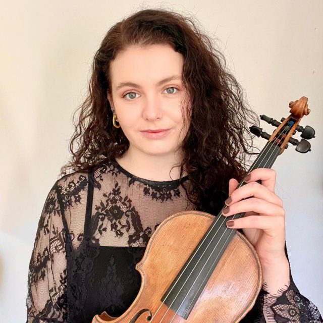 Claudia Tarrant-Matthews holds her violin