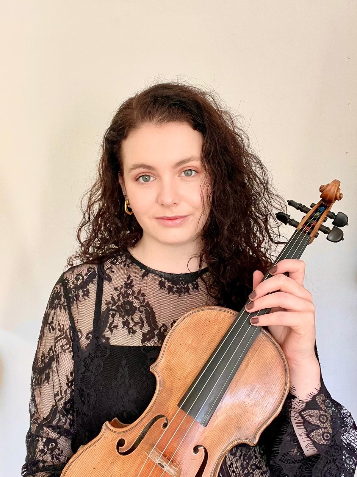 Claudia Tarrant-Matthews holds her violin