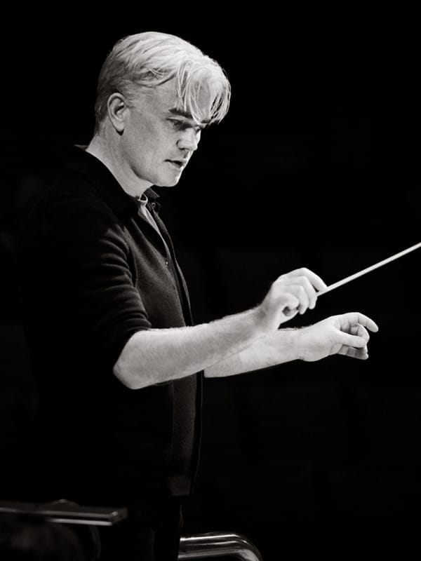 Principal Conductor Edward Gardner with baton raised at mid-height