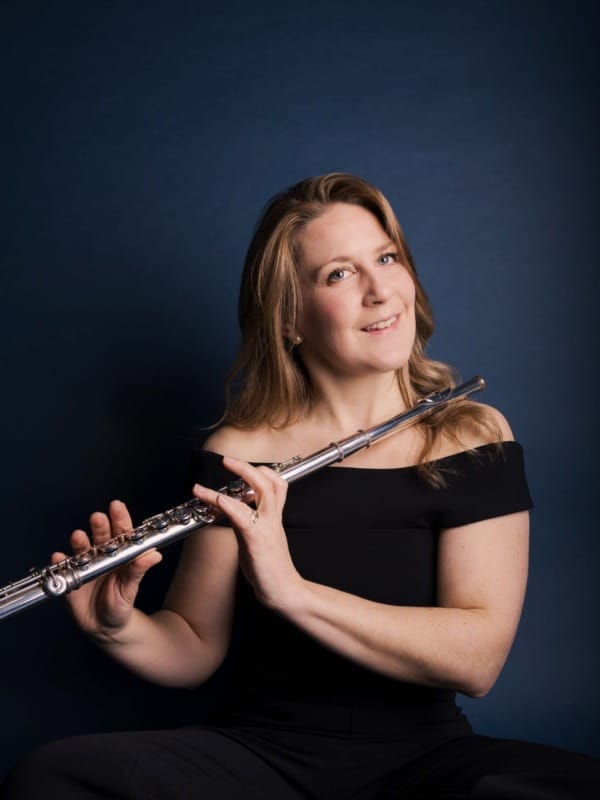 Hannah Grayson wearing a black dress and holding her flute
