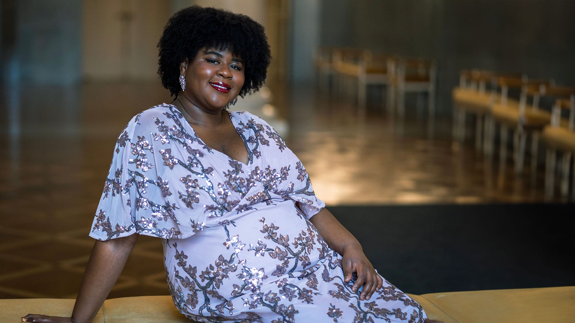 Mezzo-soprano Natalie Lewis, a woman with dark curly hair, elegant formal portrait.