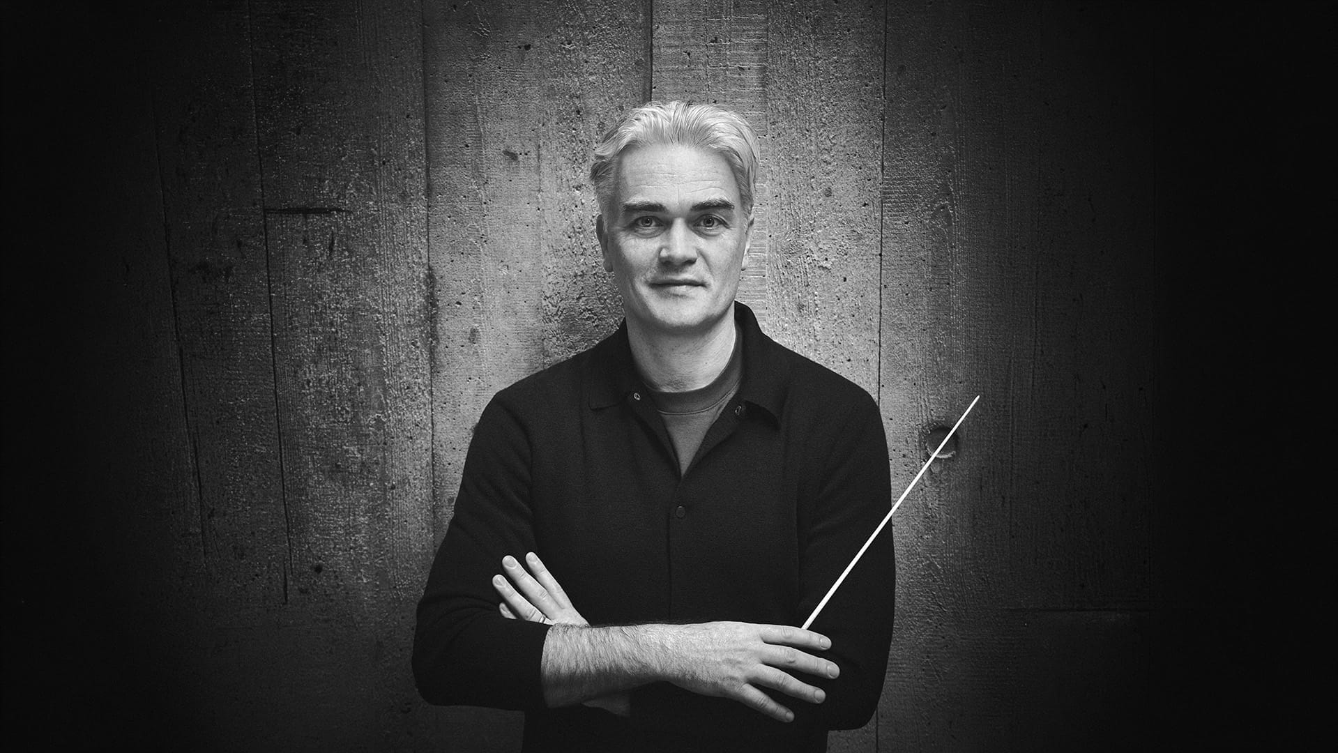 Conductor Edward Gardner, a man with short silver hair, conducting with a baton, black and white photograph.