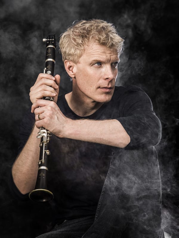 Headshot of Martin Frost, holding up his clarinet.