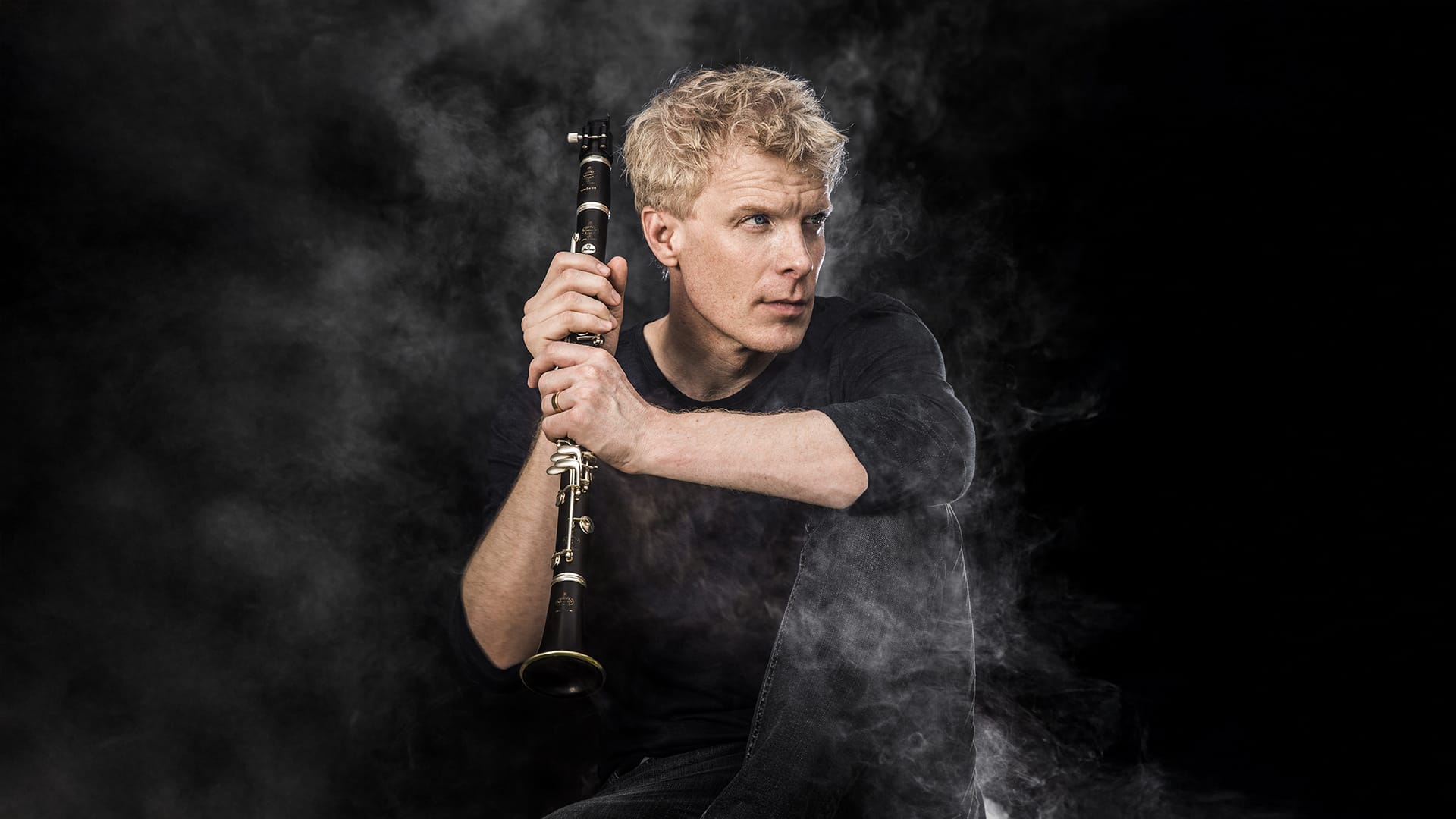 Headshot of Martin Frost, holding up his clarinet.