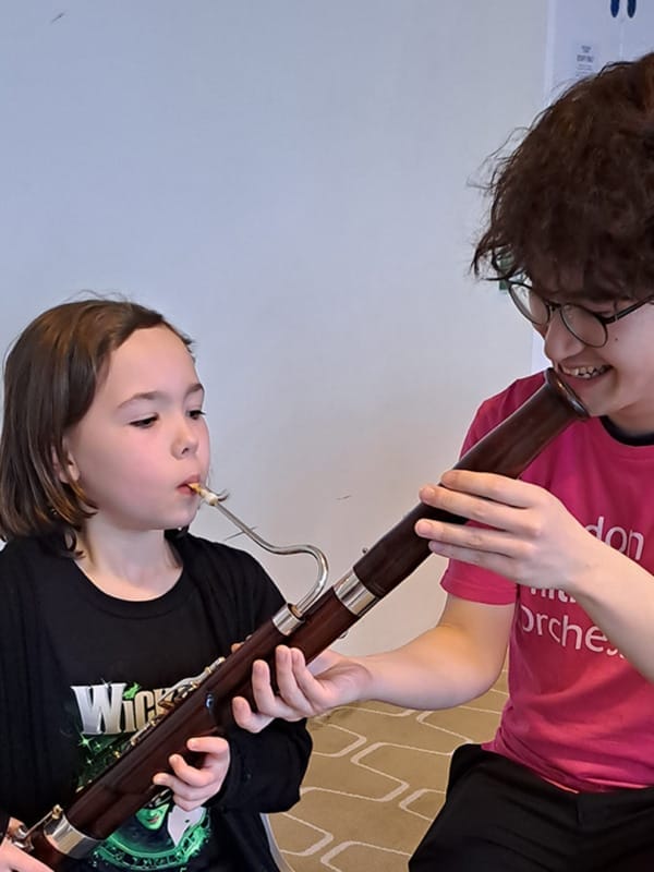 Young FUNharmonics participant plays the bassoon, helped by an LPO Future First.
