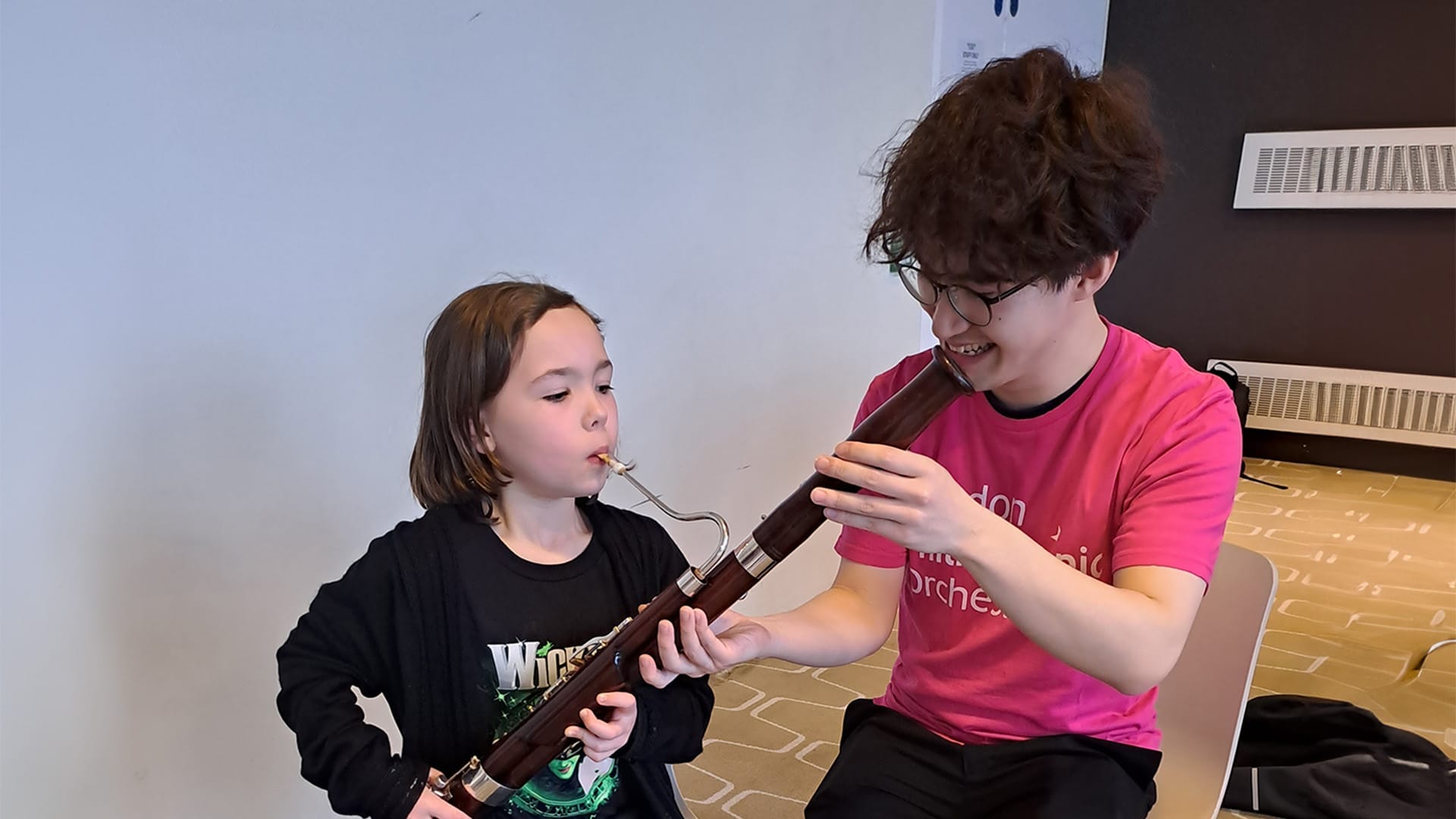 Young FUNharmonics participant plays the bassoon, helped by an LPO Future First.