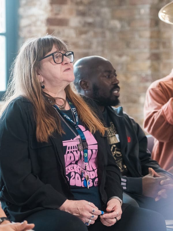 Crisis Creates participant sits contemplatively in a workshop.